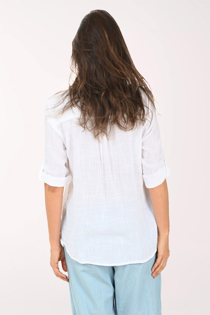 Woman wearing a 3/4 roll sleeve white blouse