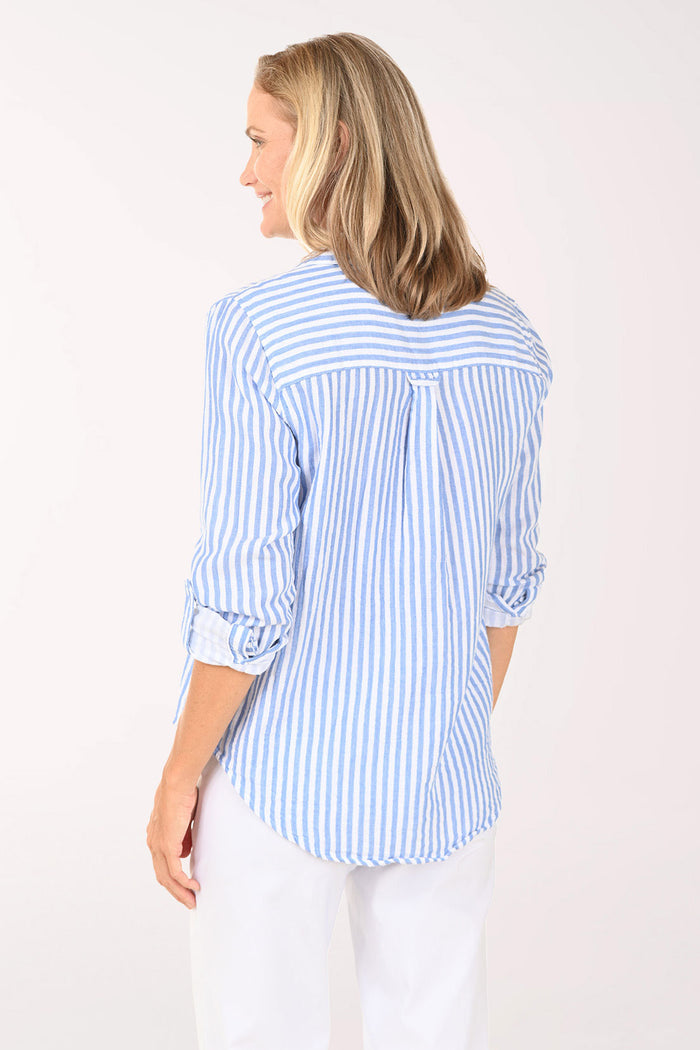Woman wearing a blue and white striped roll sleeve shirt