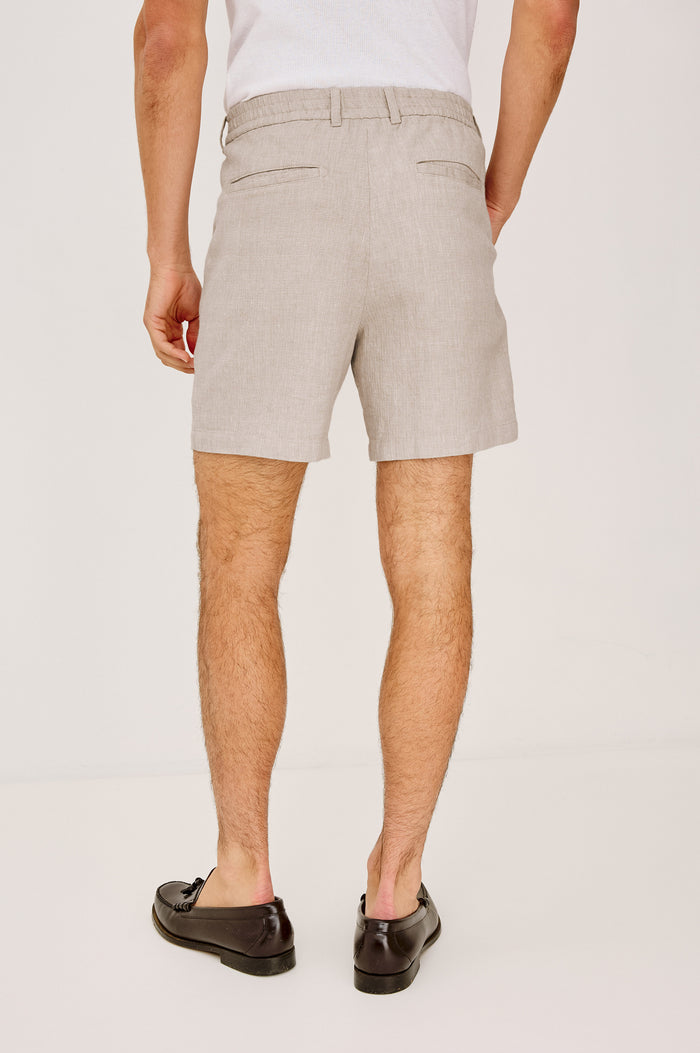 Wilson Short in Linen With a Straight Fit, Clean Front Waistband, Elasticated Back, Front Zip Fly, and Side Pockets in Sand Dune Colorway - Lower Body Back View Featured on Model
